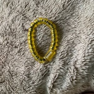 yellow, off of SHEIN. has a cute saying and is comfy around the wrist